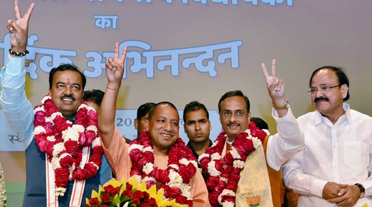 Lucknow: BJP's Yogi Adityanath (C) elected leader of the BJP Legislature Party (Chief Minister Uttar Pradesh) K P Muriya (L Deputy CM) and Dinesh Sharma (R Deputy CM) showing victory sign after the meeting in Lucknow on Saturday.PTI Photo by Nand Kumar (PTI3_18_2017_000173B)